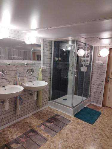 a bathroom with two sinks and a shower at Pension Panorama in Tanvald