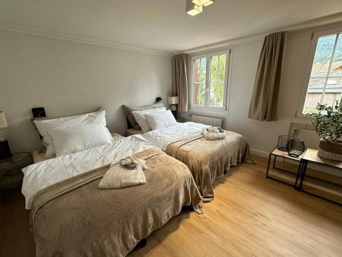 a bedroom with two beds with towels on them at Chalet-Simmi in Wimmis