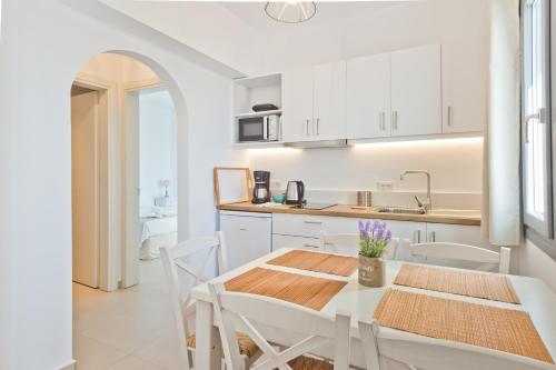 a kitchen and dining room with a table and chairs at Alsalos villas in Amoopi