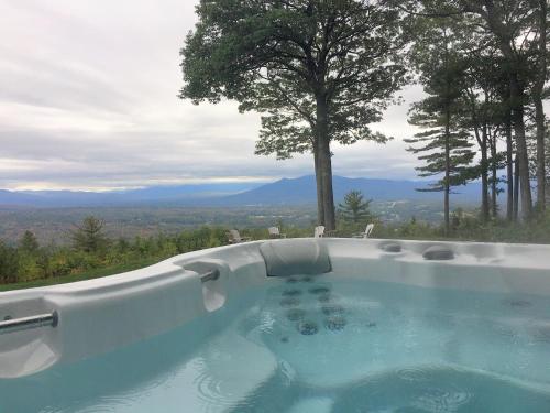 a hot tub with a view of the mountains at RL Breathtaking views and grand unique style private mountain retreat 4WD recommended in Whitefield