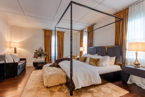 a bedroom with a four poster bed and a couch at Doctor Sax House in Lenox