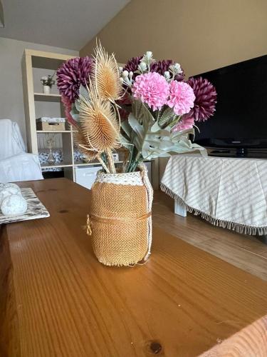 a vase filled with flowers sitting on a table at Aire de valsain in La Pradera de Navalhorno