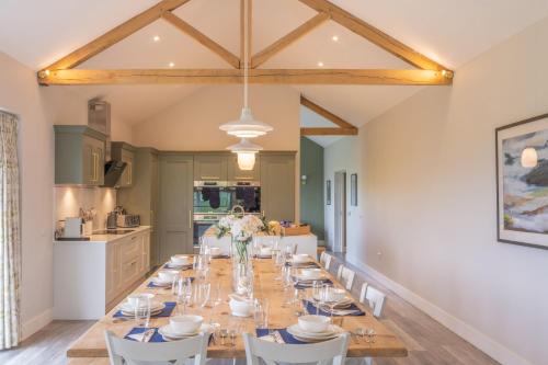 a large dining room with a long table and chairs at Downs in Blewbury