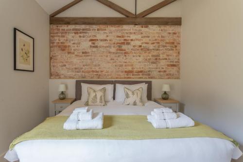 a bedroom with a large white bed with two pillows at Downs in Blewbury