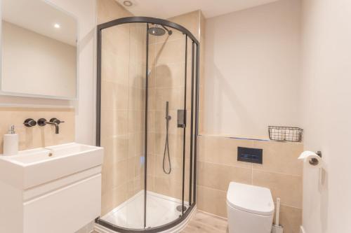 a bathroom with a shower and a toilet and a sink at Downs in Blewbury