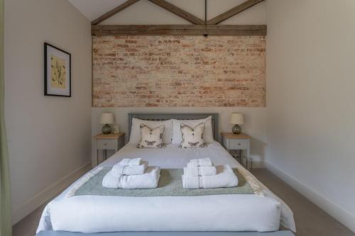 a bedroom with a bed with towels on it at Downs in Blewbury