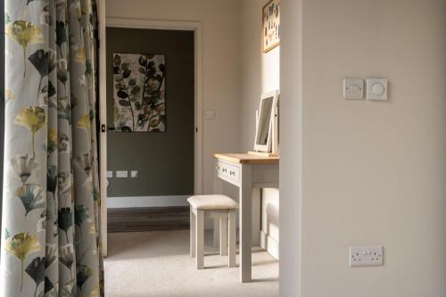 a room with a desk with a computer and a chair at Downs in Blewbury