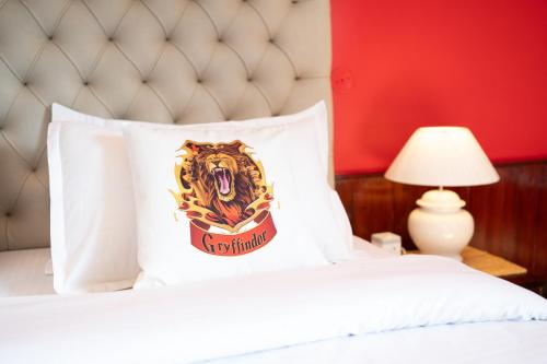 a pillow with a tiger on it sitting on a bed at Wizards Den-Harry Potter inspired 3BHK in Mashobra in Mashobra
