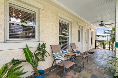 a porch with two chairs and two windows at Wine-Dine-Sunshine Cozy Flat in The Heart of DTSP in St. Petersburg
