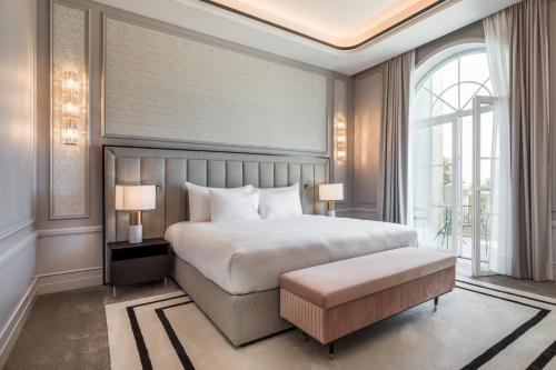 a bedroom with a large bed and a large window at Maison Albar - Amoure in Braga