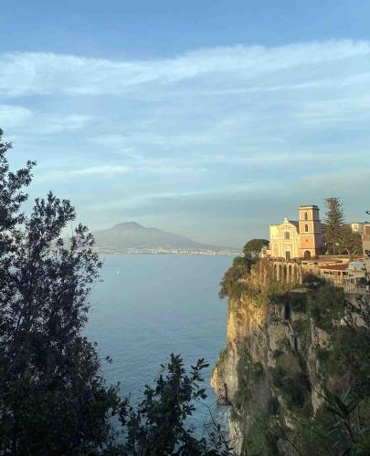 a view of a body of water with houses on a cliff at MareHolidays in Vico Equense