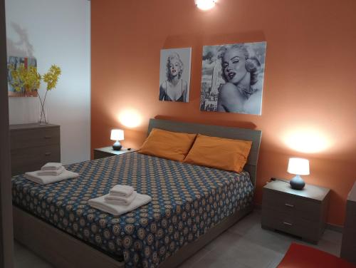 a bedroom with a bed and two pictures on the wall at Casa Vacanze di Alex in Càbras