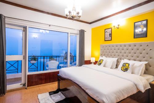 a bedroom with a large bed and a large window at Wizards Den-Harry Potter inspired 3BHK in Mashobra in Mashobra