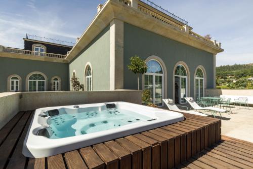 a hot tub on the deck of a house at Maison Albar - Amoure in Braga