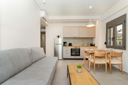 a living room and kitchen with a couch and a table at Dreta Suites in Chania Town