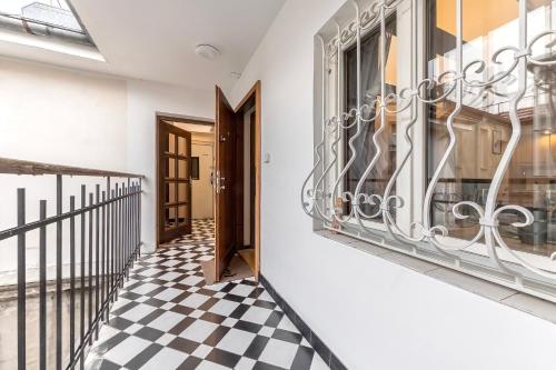 a hallway with a black and white checkered floor at The Wenceslas Loft in Prague