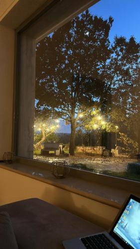 a window with a view of a tree and a table at oasi di pace fasano BIS in Fasano