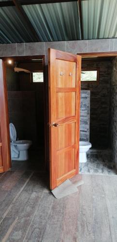 an open door to a bathroom with a toilet at Mano Verde Minca in Minca