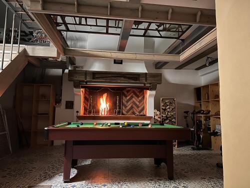 a pool table in a room with a fireplace at Ateliér Kráľovič in Hokovce