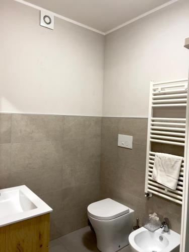 a bathroom with a white toilet and a sink at Casa Celeste in Nocera Umbra