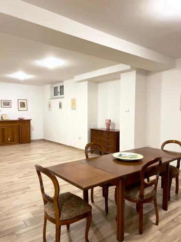 a dining room with a wooden table and chairs at Casa Celeste in Nocera Umbra