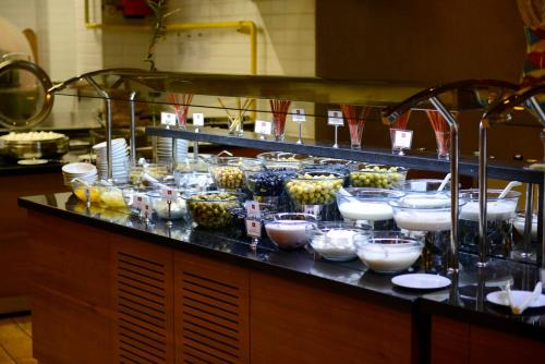 a counter with many bowls of food on it at Crowne Plaza Kayseri by IHG in Kayseri