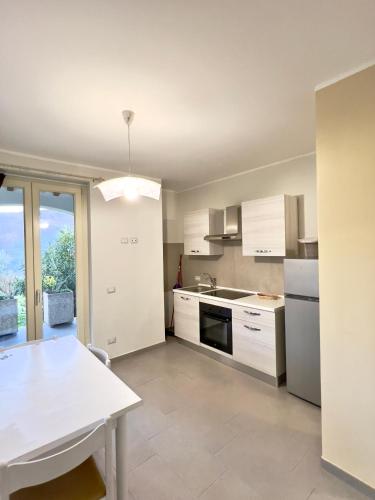 a kitchen with white cabinets and a white table at Casa Celeste in Nocera Umbra