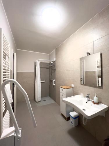 a white bathroom with a sink and a shower at Casa Celeste in Nocera Umbra