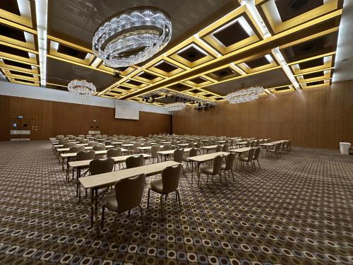 a large room with tables and chairs and chandeliers at Crowne Plaza Kayseri by IHG in Kayseri