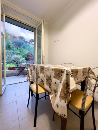 a dining room with a table and chairs and a window at Casa Celeste in Nocera Umbra