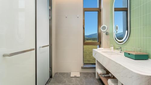 a bathroom with a sink and a mirror at Holiday Inn Liaoyuan City Center by IHG in Liaoyuan