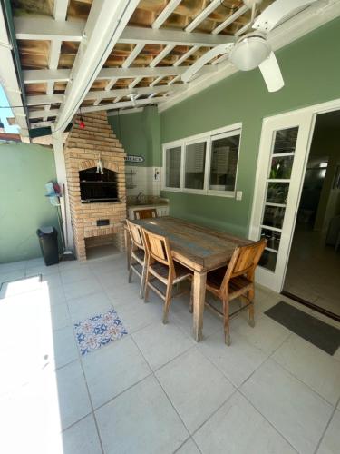 a dining room with a wooden table and chairs at Casa 1 na praia de Juqueí em Condomínio in Juquei