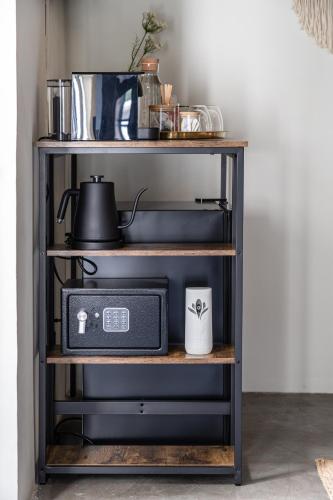 a shelf with a radio and a cup on it at Casa Lumos - Minimalist Comfort Suites in Centro Historico in Oaxaca City