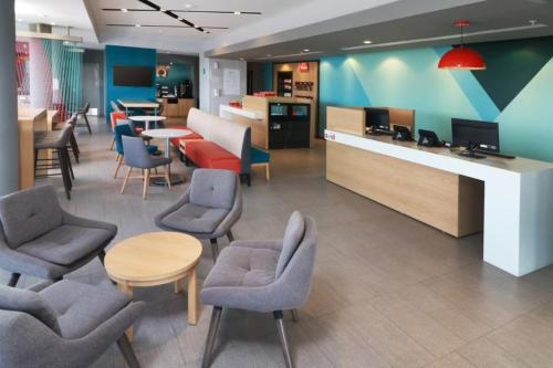 a waiting room with chairs and tables in a hospital at Avid Hotel Querétaro Centro Sur by IHG in Querétaro