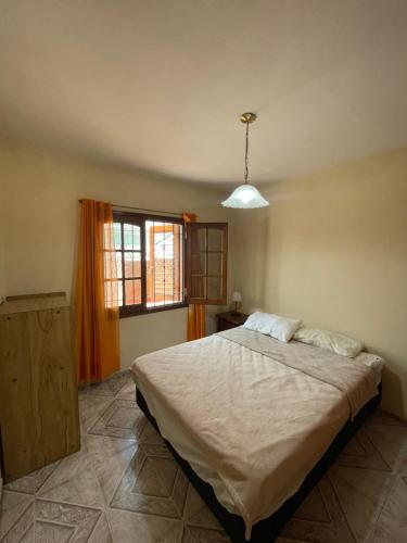 a bedroom with a large bed and a window at Casa FLORENCIA Céntrica in Villa Carlos Paz
