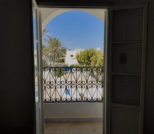 an open door to a balcony with a fence at Dar Dalenda in Mezraya