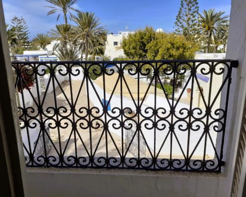 a balcony with a wrought iron fence and a beach at Dar Dalenda in Mezraya