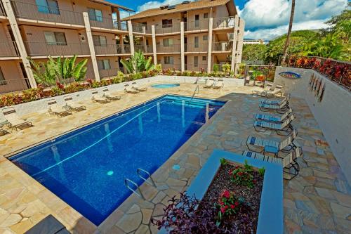 a swimming pool in front of a hotel at Stylish Maui Loft Split AC Ocean Views Lanai in Kihei