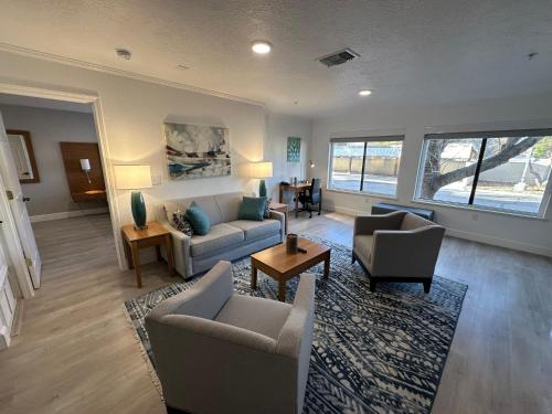 a living room with a couch and chairs and a table at B&J Hotels in Roswell