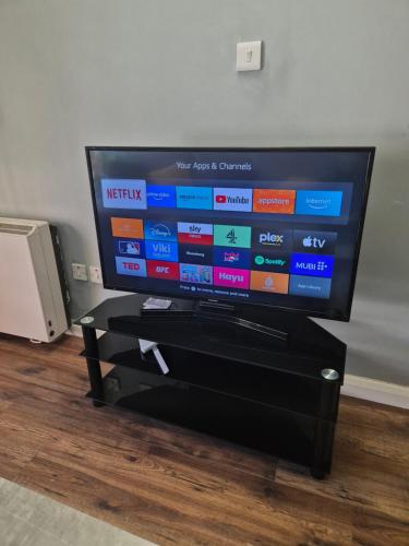 a flat screen tv sitting on a black entertainment center at 2bed city centre apartment in Limerick