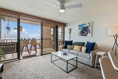 a living room with a couch and a table at Oceanfront Condo with Heated Pool Hot Tub & Lanai in Wailuku