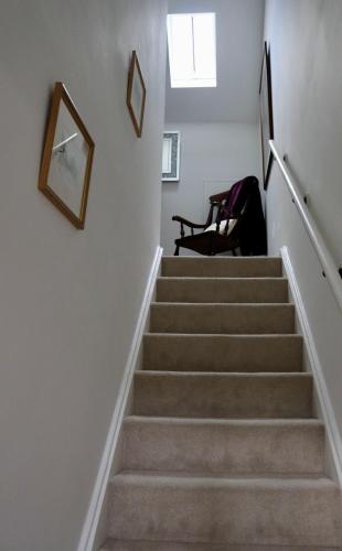 a staircase in a house with a picture on the wall at Thornton House Town Centre Free Car Park in Cheltenham