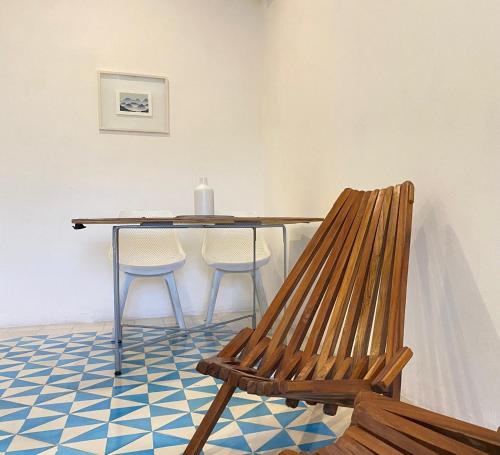 a dining room table with two chairs and a bench at Studios Downtown Cancun in Cancún