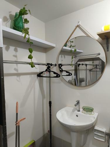 a bathroom with a sink and a mirror at Miranda's Suite by Fullerton in Silang