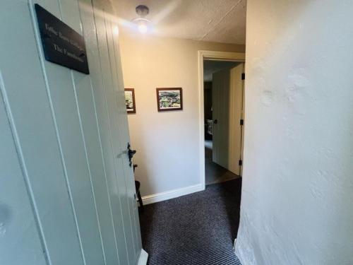 a hallway with a room with a door and a hallway at The Farmhouse in Easington