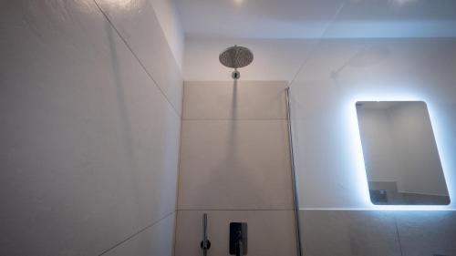 a bathroom with a shower with a mirror at Modern Room in Olbia