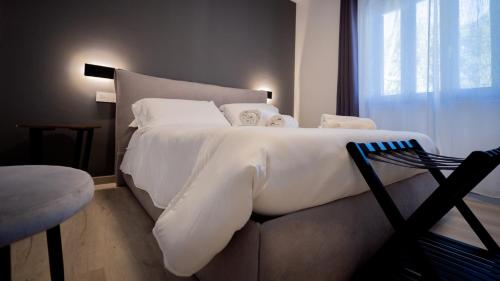 a bedroom with a large white bed and a window at Modern Room in Olbia