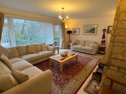 a living room with couches and a coffee table at Birchcroft Hideaway in Ferndown