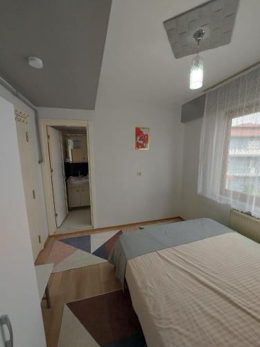 a bedroom with a bed in a room with a window at Zeytin Apart Daire 7 in Pamukkale