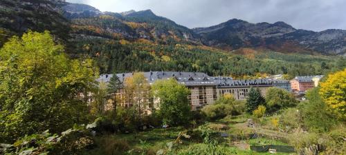 a large building in the middle of a mountain at Carlina Canfranc in Canfranc-Estación